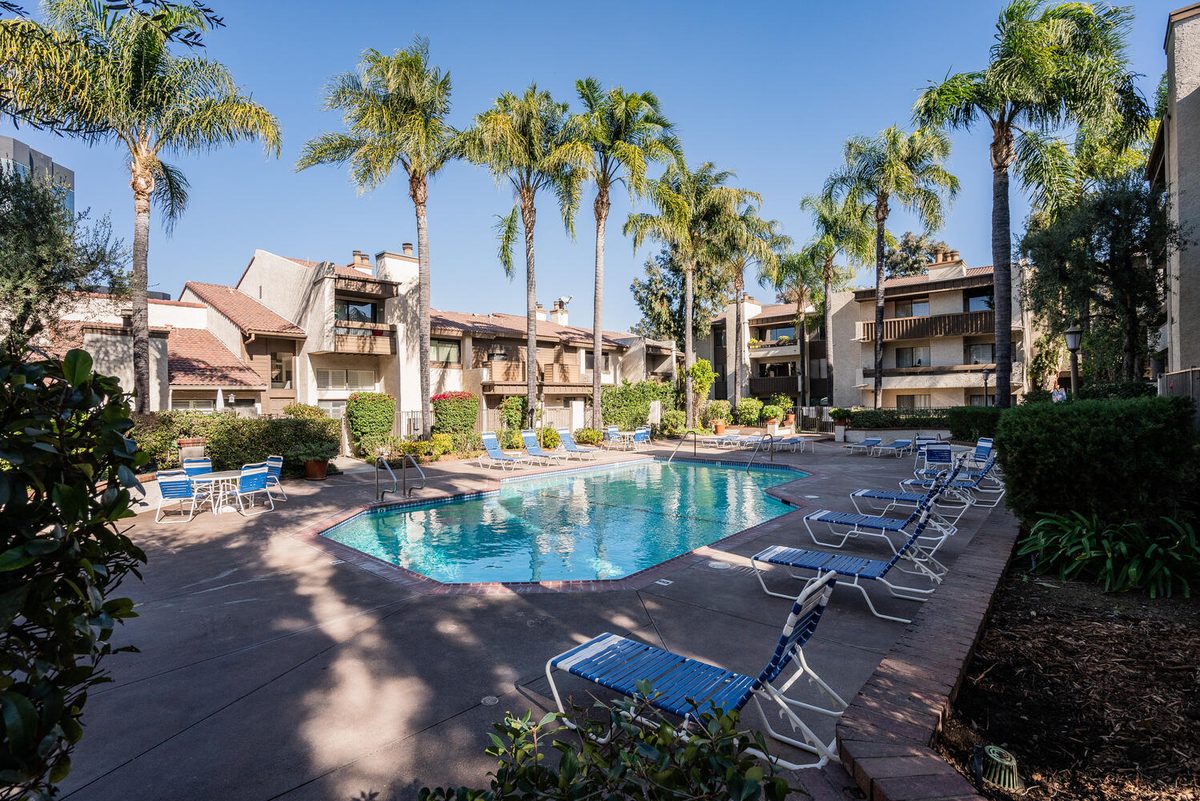 Warner Club Villas resort pool with palm trees — 5800 Owensmouth Woodland Hills